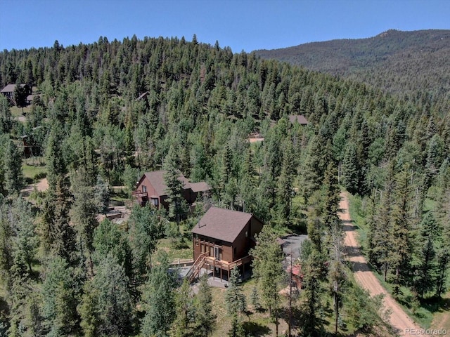 10438 Sunlight Ln, Conifer, CO 80433 - aerial view of property and surrounding area featuring a forest and mountains