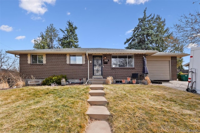 view of front of house with a front yard, an attached garage, and brick siding