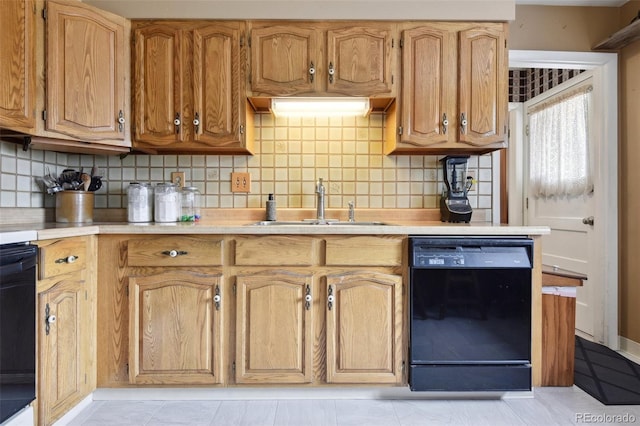 kitchen with a sink, decorative backsplash, black dishwasher, and light countertops