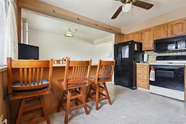 kitchen featuring black appliances, a ceiling fan, tasteful backsplash, and light countertops