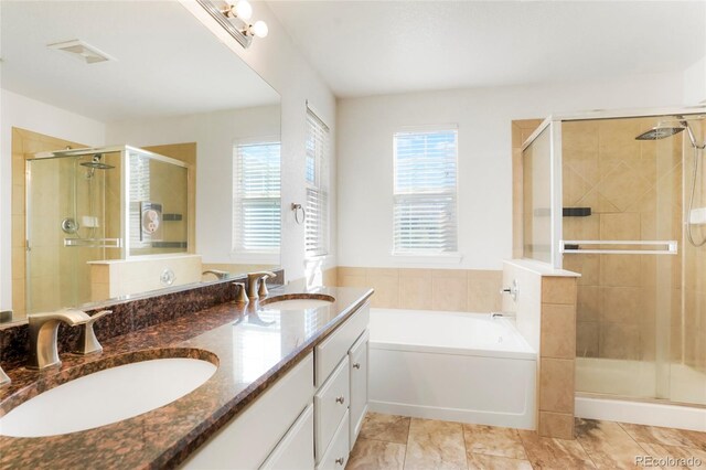 bathroom featuring shower with separate bathtub and vanity