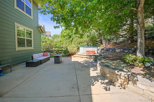 view of patio featuring outdoor lounge area and a jacuzzi