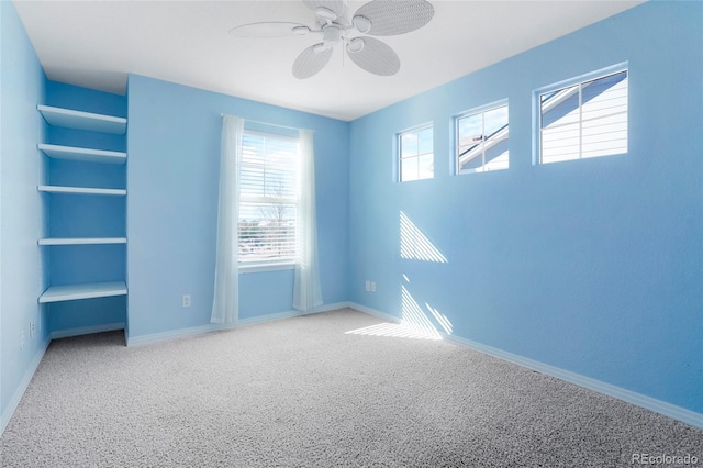 empty room featuring carpet floors and ceiling fan