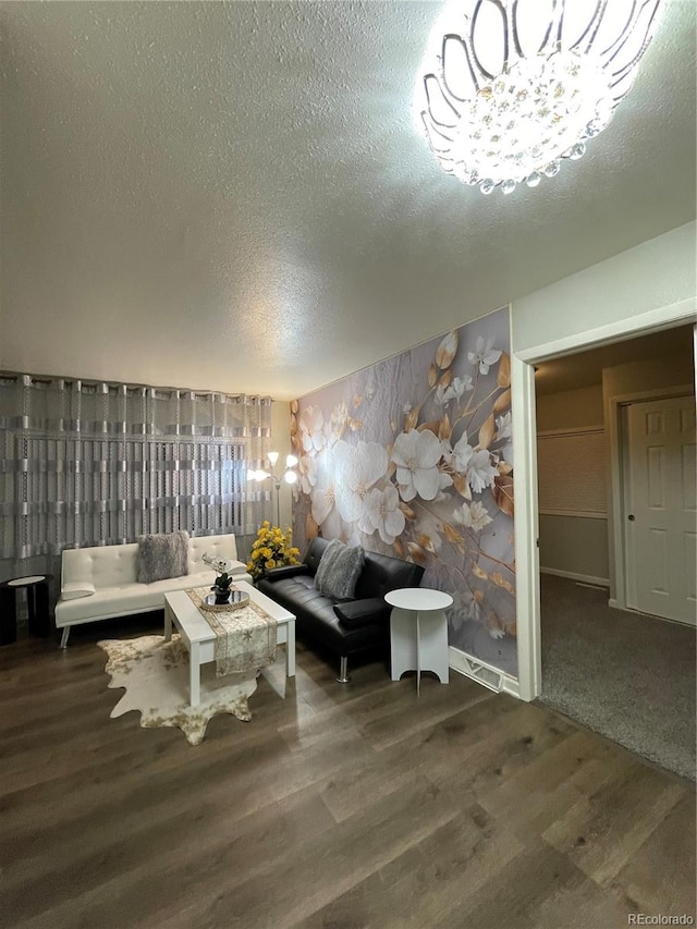 unfurnished living room with a textured ceiling and dark hardwood / wood-style floors