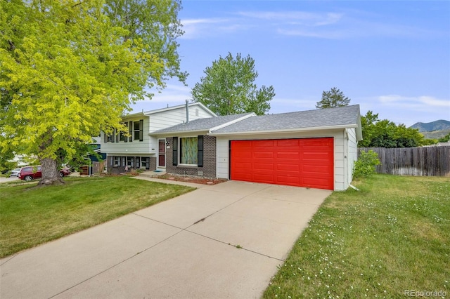 4511 S Braun Ct, Morrison, CO 80465 - split level home with an attached garage, driveway, and brick siding