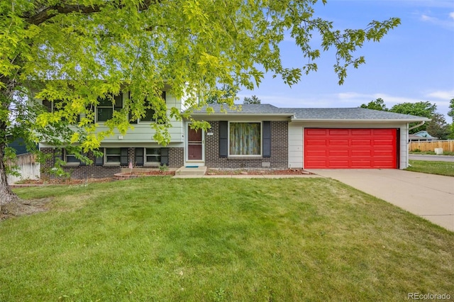 4511 S Braun Ct, Morrison, CO 80465 - split level home with a garage, concrete driveway, a front yard, and brick siding