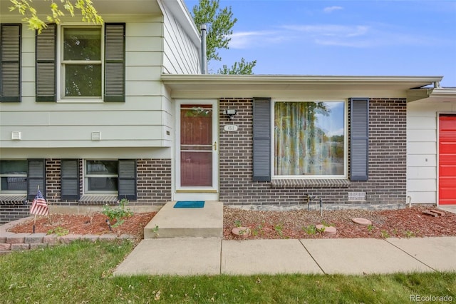 4511 S Braun Ct, Morrison, CO 80465 - view of exterior entry featuring brick siding and a garage