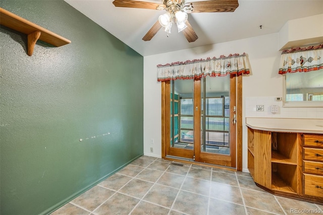 4511 S Braun Ct, Morrison, CO 80465 - unfurnished dining area with ceiling fan, a textured wall, and light tile patterned floors
