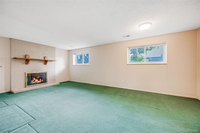 4511 S Braun Ct, Morrison, CO 80465 - unfurnished living room featuring carpet floors, a fireplace, and a textured ceiling