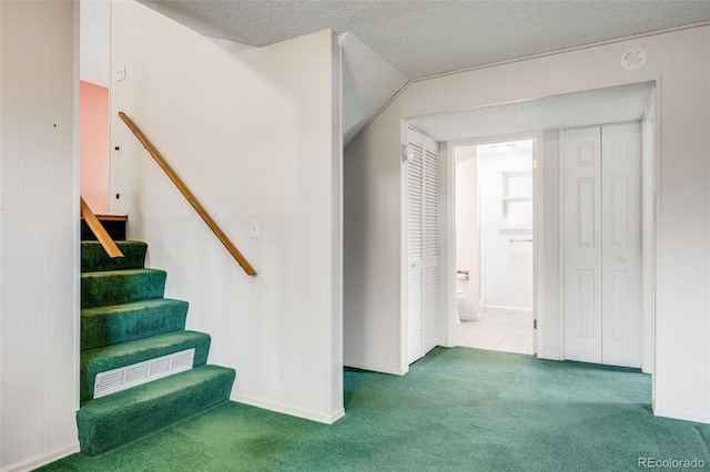 4511 S Braun Ct, Morrison, CO 80465 - staircase featuring carpet flooring and a textured ceiling