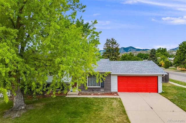 4511 S Braun Ct, Morrison, CO 80465 - view of front of home with a garage, a front yard, driveway, and a mountain view