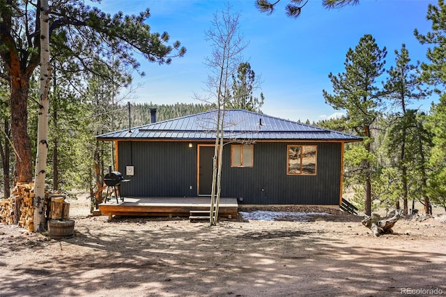 29 Deerfield Ln, Florissant, CO 80816 - back of property with a wooden deck and metal roof