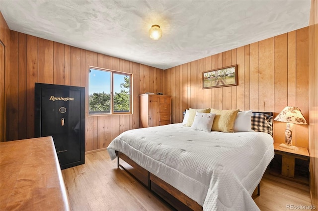 29 Deerfield Ln, Florissant, CO 80816 - bedroom featuring light wood-style floors, wood walls, and baseboards