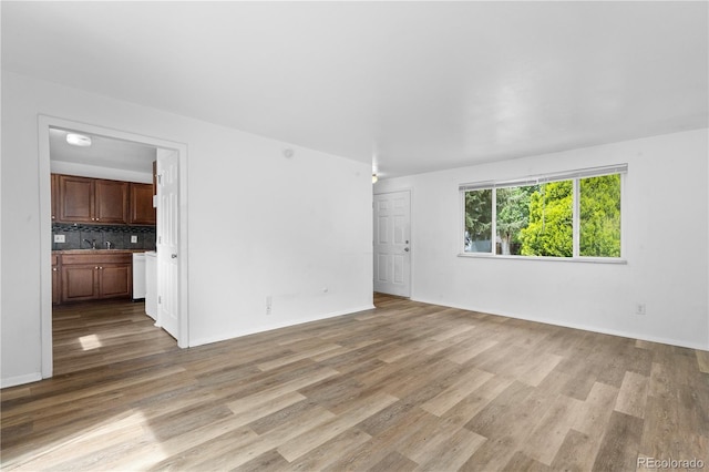 1235 S Benton St, Lakewood, CO 80232 - unfurnished living room with light wood finished floors