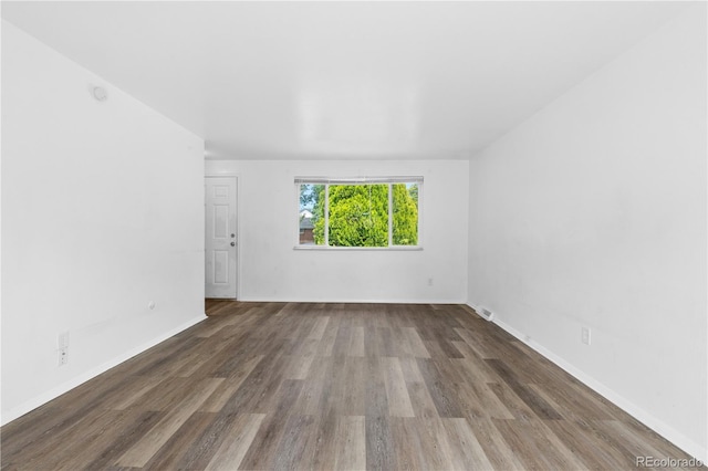 1235 S Benton St, Lakewood, CO 80232 - empty room with wood finished floors and baseboards