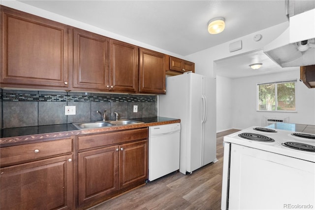 1235 S Benton St, Lakewood, CO 80232 - kitchen featuring white appliances, light wood finished floors, exhaust hood, brown cabinets, and tasteful backsplash