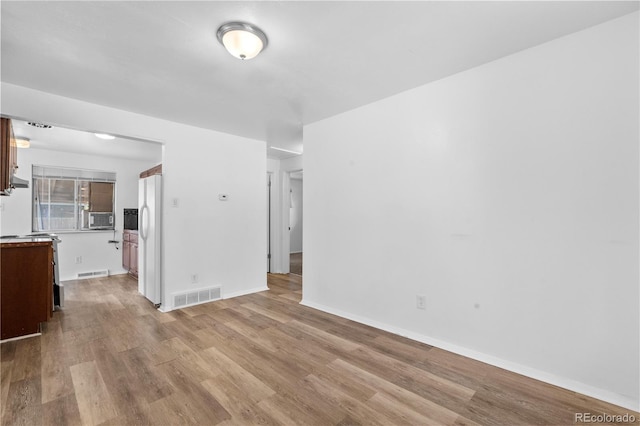 1235 S Benton St, Lakewood, CO 80232 - unfurnished living room with light wood-style flooring and baseboards