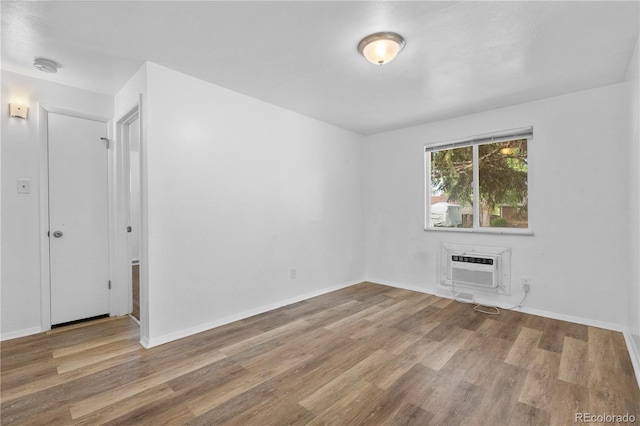 1235 S Benton St, Lakewood, CO 80232 - spare room with wood finished floors, a smoke detector, and a wall unit AC