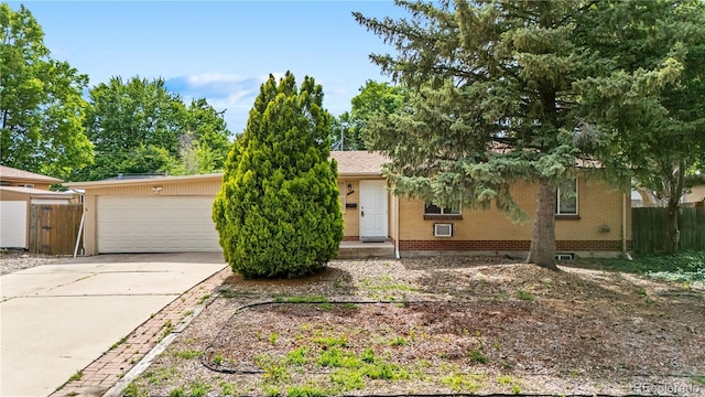 1235 S Benton St, Lakewood, CO 80232 - obstructed view of property with brick siding and concrete driveway