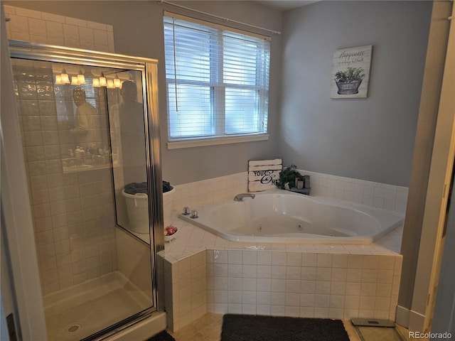 bathroom with tile patterned flooring and separate shower and tub