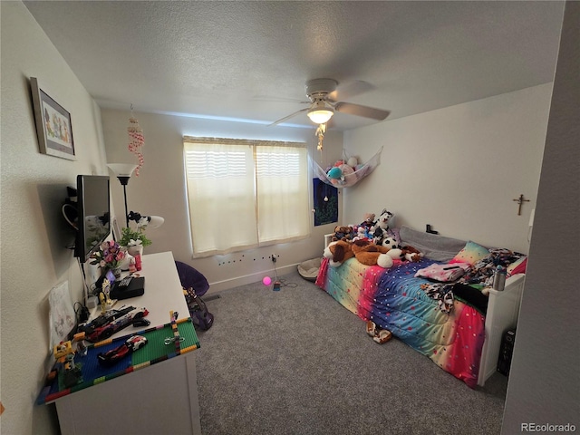 carpeted bedroom with a textured ceiling and ceiling fan