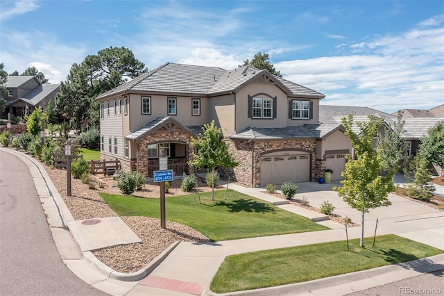 6728 S Catawba Way, Aurora, CO 80016 - view of front of property featuring stucco siding, driveway, stone siding, a front yard, and a garage