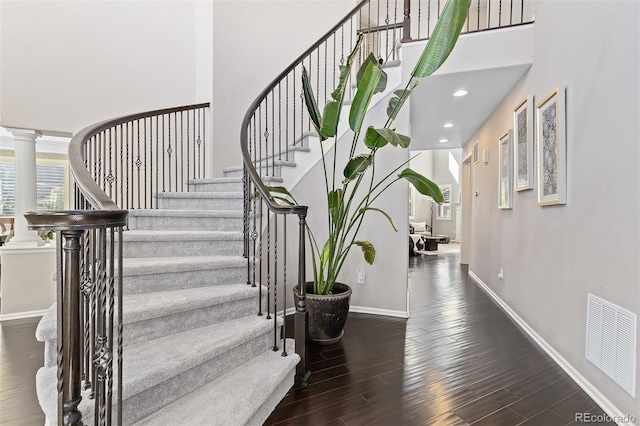 6728 S Catawba Way, Aurora, CO 80016 - stairway featuring wood finished floors, a towering ceiling, and recessed lighting