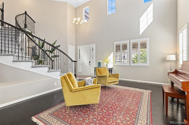 6728 S Catawba Way, Aurora, CO 80016 - living room with wood finished floors, a towering ceiling, stairway, healthy amount of natural light, and a chandelier