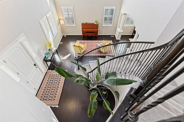 6728 S Catawba Way, Aurora, CO 80016 - stairway featuring wood finished floors, decorative columns, and a towering ceiling
