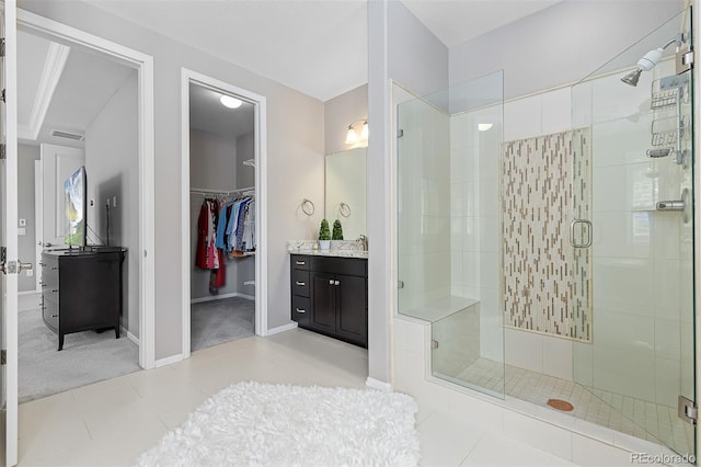 6728 S Catawba Way, Aurora, CO 80016 - full bath featuring vanity, a stall shower, a spacious closet, and tile patterned flooring