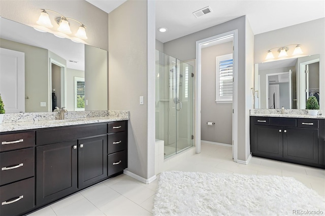 6728 S Catawba Way, Aurora, CO 80016 - full bath with a shower stall, two vanities, and tile patterned flooring