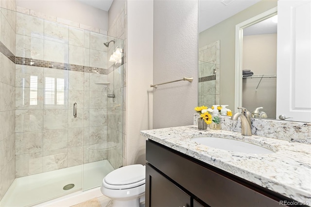 6728 S Catawba Way, Aurora, CO 80016 - full bathroom with vanity, a shower stall, a spacious closet, and a textured wall