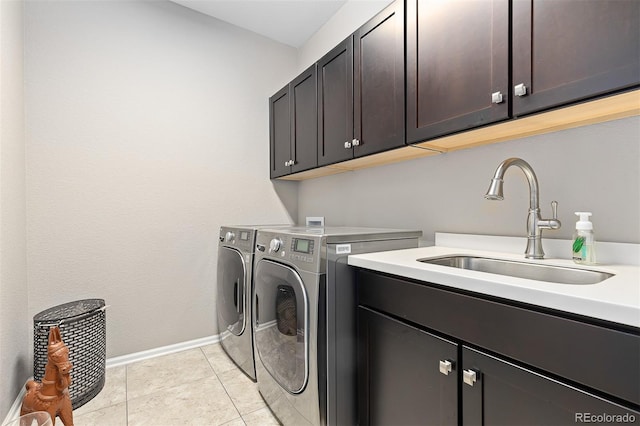6728 S Catawba Way, Aurora, CO 80016 - laundry room featuring cabinet space, washing machine and dryer, and light tile patterned floors
