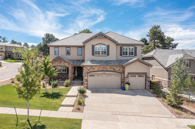 6728 S Catawba Way, Aurora, CO 80016 - view of front of property with stucco siding, a garage, driveway, stone siding, and a front yard