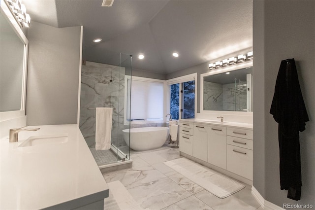 bathroom featuring shower with separate bathtub and vanity