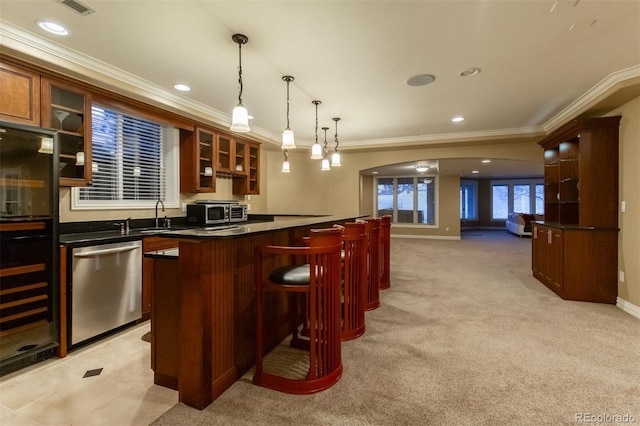 bar with pendant lighting, dishwasher, sink, crown molding, and light carpet