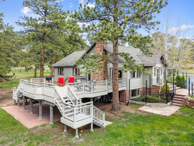 640 Pinewood Ln, Estes Park, CO 80517 - back of property with stairway, roof with shingles, a wooden deck, and a chimney