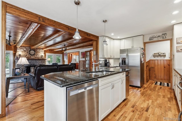640 Pinewood Ln, Estes Park, CO 80517 - kitchen with stainless steel appliances, a sink, light wood-style flooring, white cabinets, and beam ceiling
