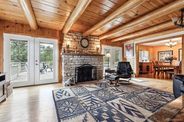 640 Pinewood Ln, Estes Park, CO 80517 - living area with wood finished floors, wood ceiling with exposed beams, a stone fireplace, french doors, and a chandelier