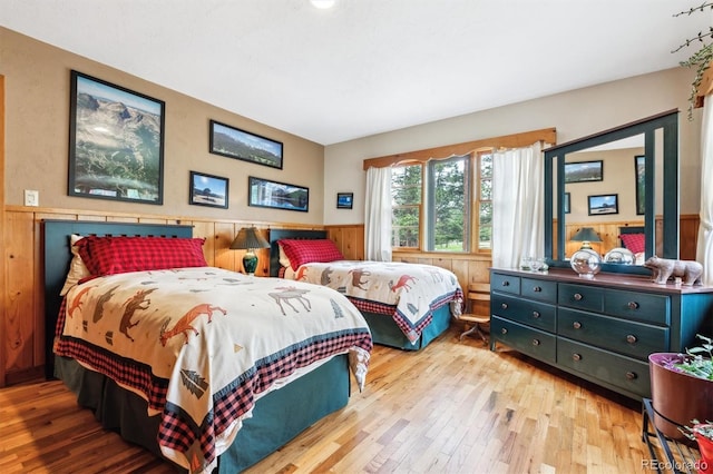 640 Pinewood Ln, Estes Park, CO 80517 - bedroom with hardwood / wood-style flooring, wainscoting, and wood walls