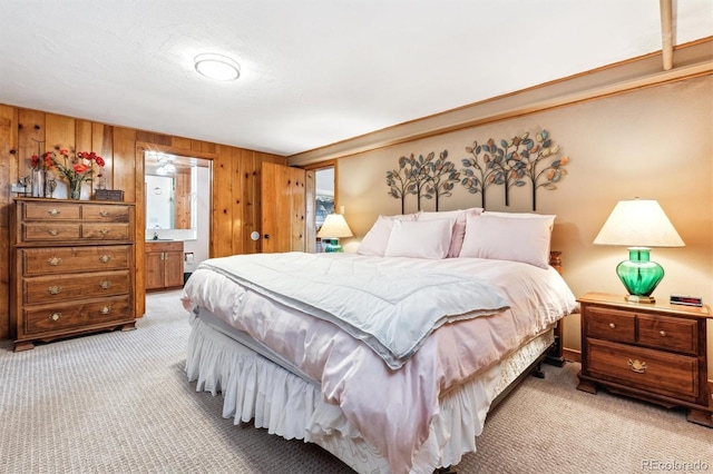 640 Pinewood Ln, Estes Park, CO 80517 - bedroom featuring light colored carpet, wood walls, and ensuite bath
