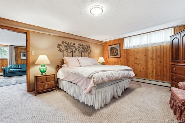 640 Pinewood Ln, Estes Park, CO 80517 - bedroom featuring baseboard heating, light carpet, and wooden walls