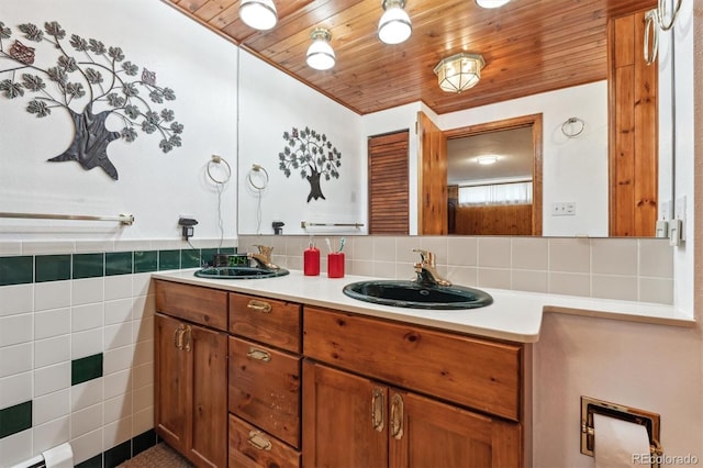 640 Pinewood Ln, Estes Park, CO 80517 - full bathroom featuring double vanity, wood ceiling, tile walls, and backsplash