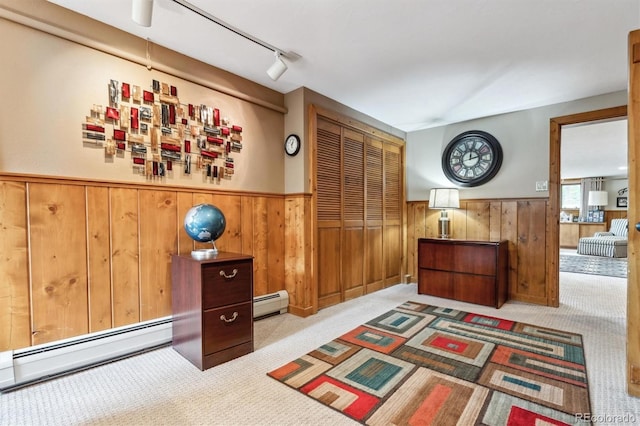 640 Pinewood Ln, Estes Park, CO 80517 - interior space featuring a wainscoted wall, carpet, wood walls, a baseboard heating unit, and track lighting