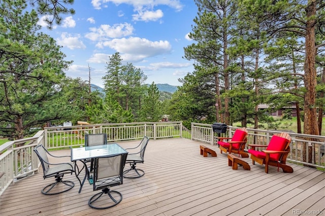 640 Pinewood Ln, Estes Park, CO 80517 - deck featuring outdoor dining area, a grill, and a mountain view