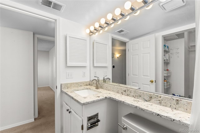 bathroom with vanity and a textured ceiling