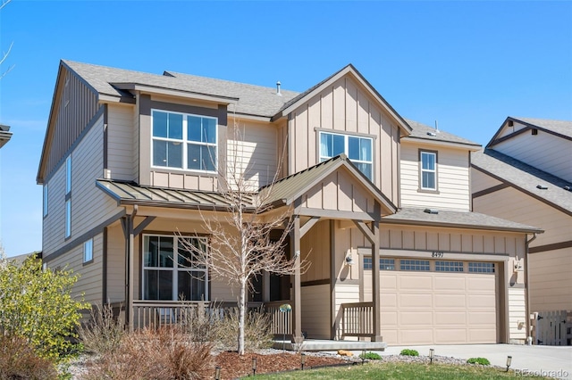craftsman house with driveway, board and batten siding, a shingled roof, and covered porch