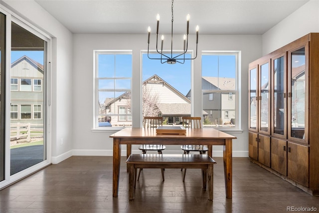 dining area with a healthy amount of sunlight, baseboards, and an inviting chandelier