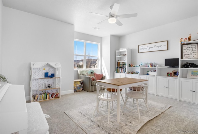 rec room featuring baseboards, visible vents, a ceiling fan, and light colored carpet