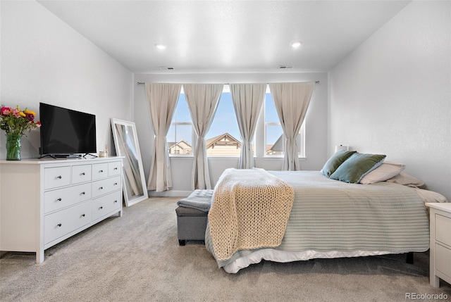 bedroom featuring light carpet, visible vents, and recessed lighting
